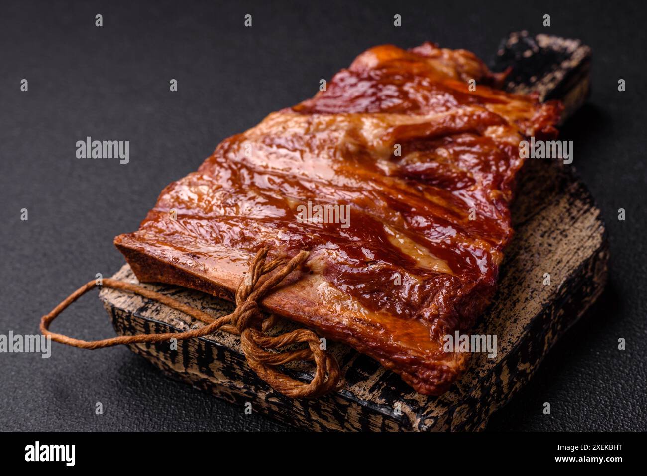 Delicious smoked or grilled ribs with olives, spices and herbs Stock Photo