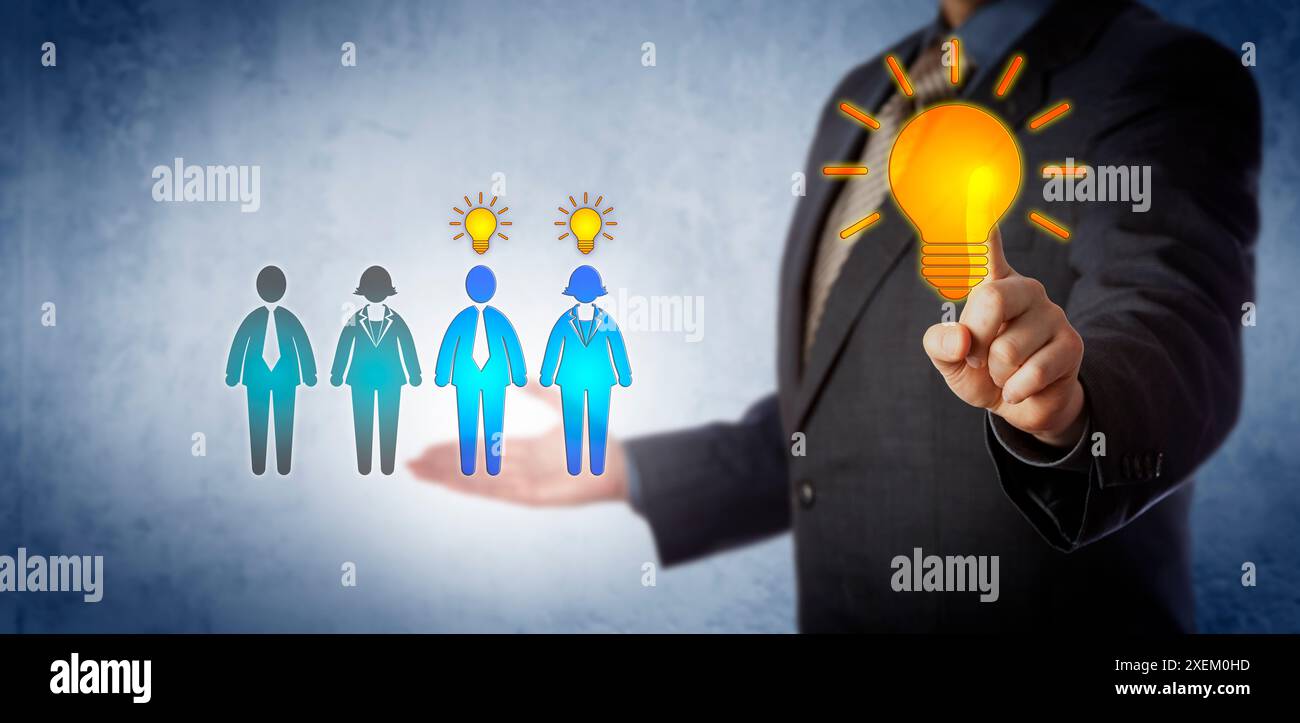 Unrecognizable corporate manager activating training for two employees in a group of four. Business concept for continued professional development, on Stock Photo