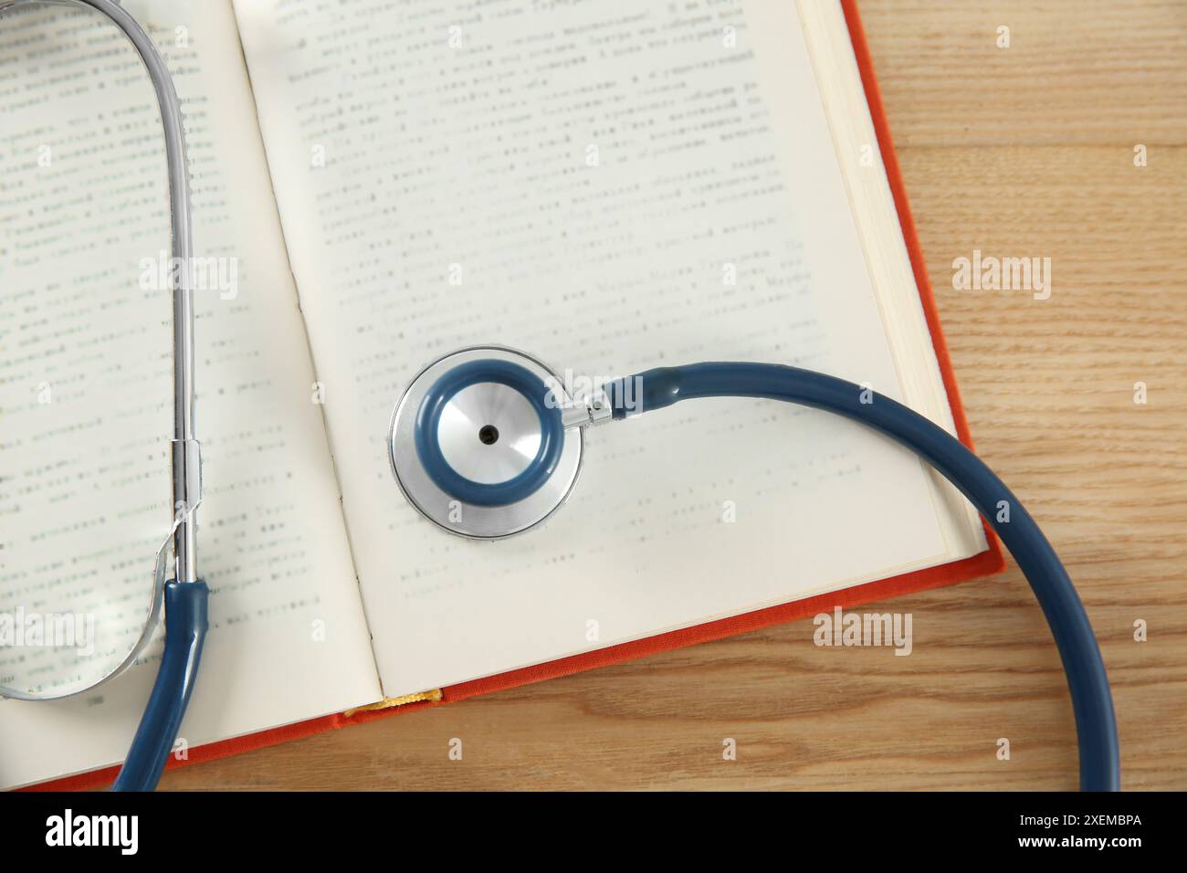 One new medical stethoscope on wooden table, top view Stock Photo