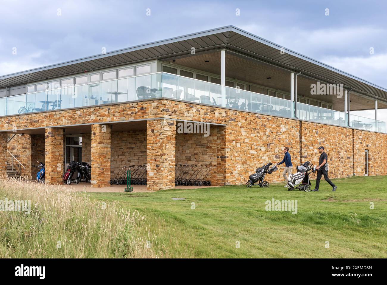 Golfers walking towards the locker room and clubhouse at Dundonald ...