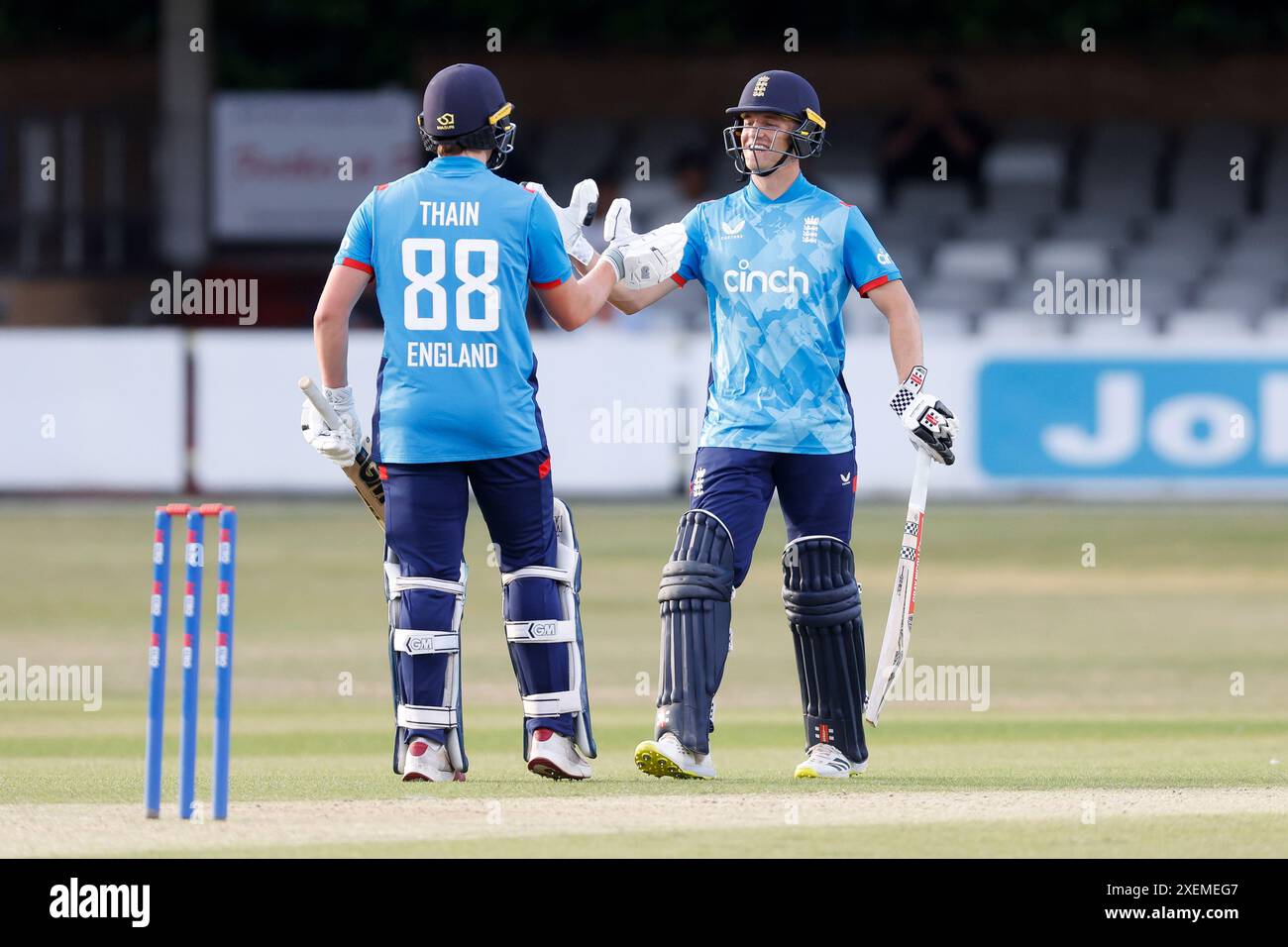 England's Noah Thain reaches a half century and is congratulated by England's Luc Benkenstein (right) during the first Youth One-Day International match at the Cloud County Ground, Chelmsford. Picture date: Thursday June 28, 2024. Stock Photo