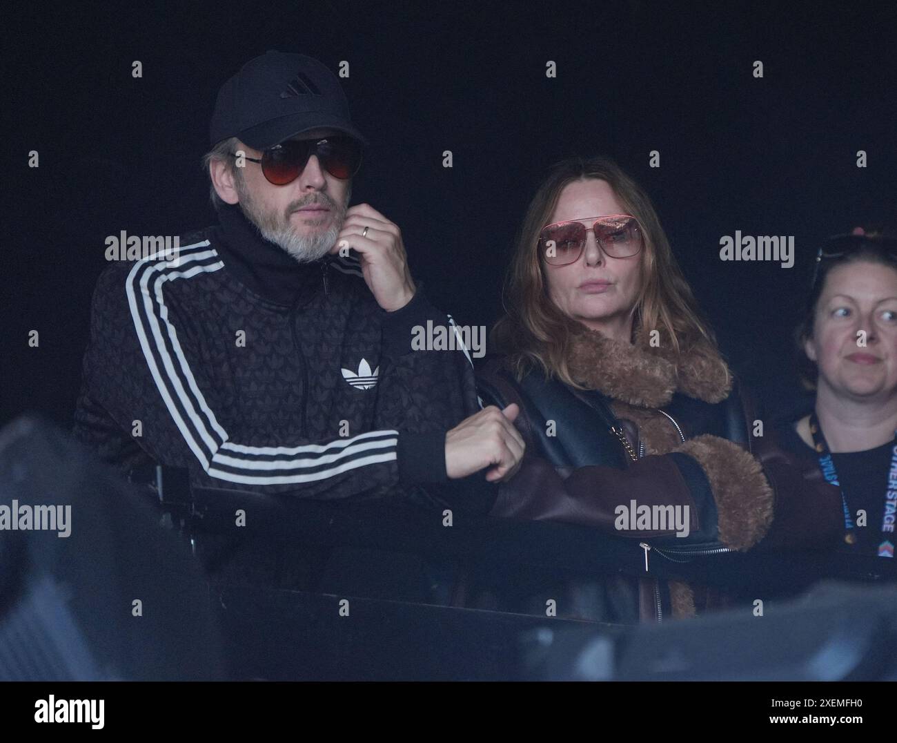 Stella McCartney and her husband Alasdhair Willis watching PJ Harvey