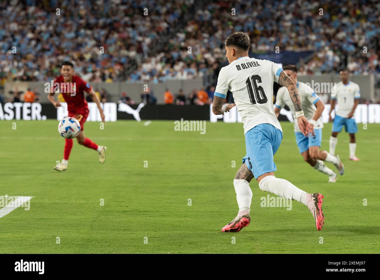Mathias Olivera of Uruguay (16) chases ball during group stage game
