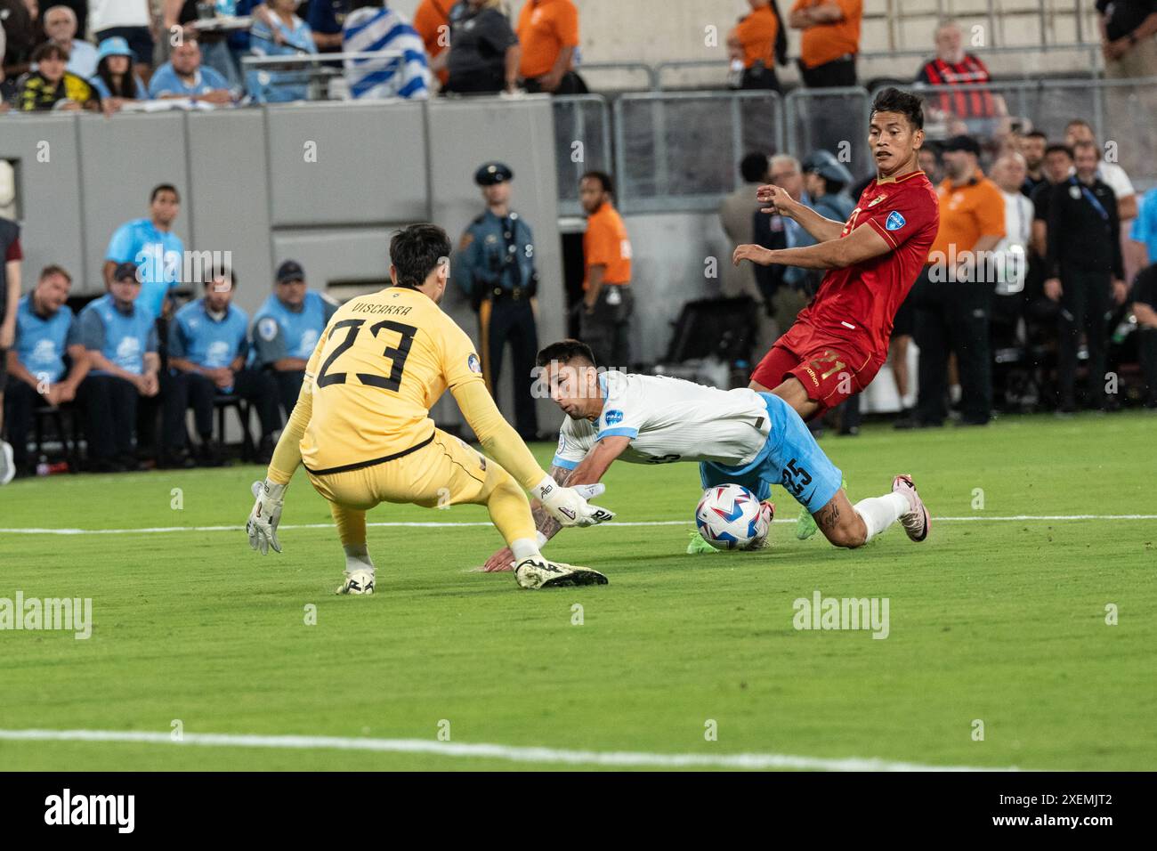Cristian Olivera (25) of Uruguay falls on challenge during group stage