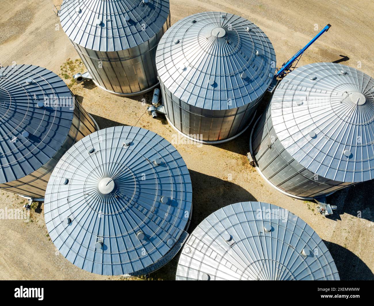 Aerial view of large metal grain bins on farmland North of Calgary, Alberta; Alberta, Canada Stock Photo