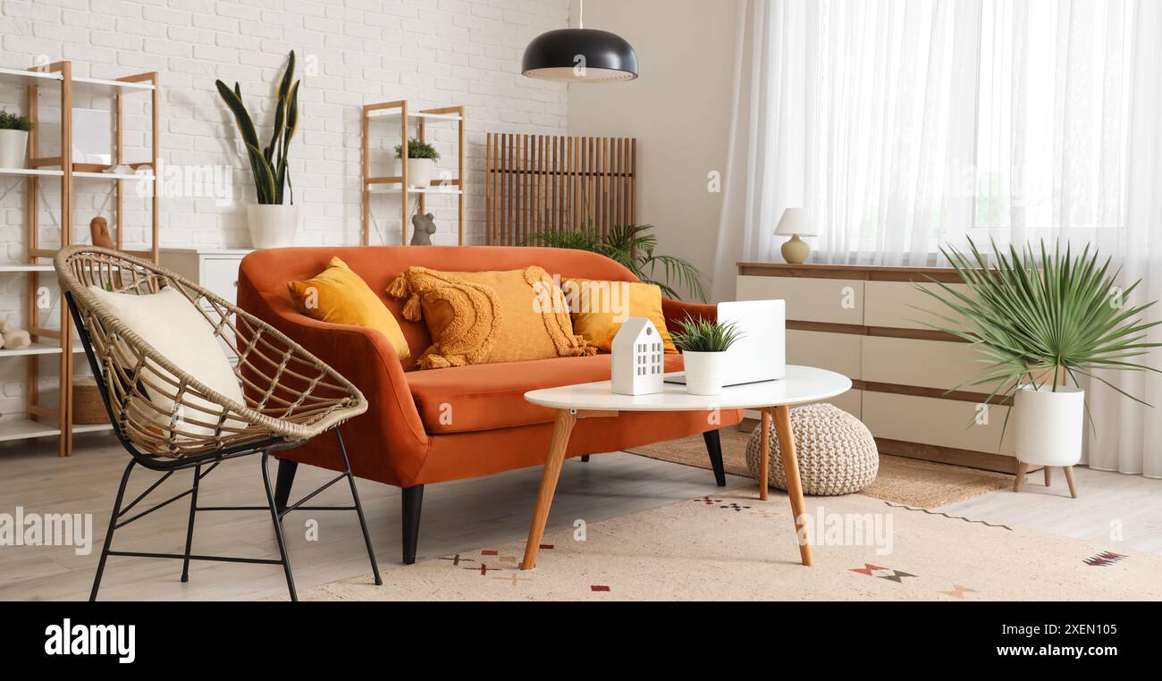 Interior of living room with orange sofa, armchair and table Stock ...
