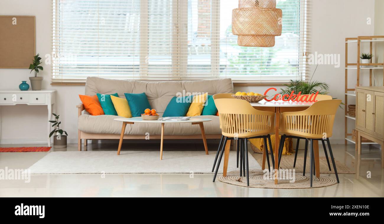Interior of stylish living room with cozy sofa and dining table Stock ...