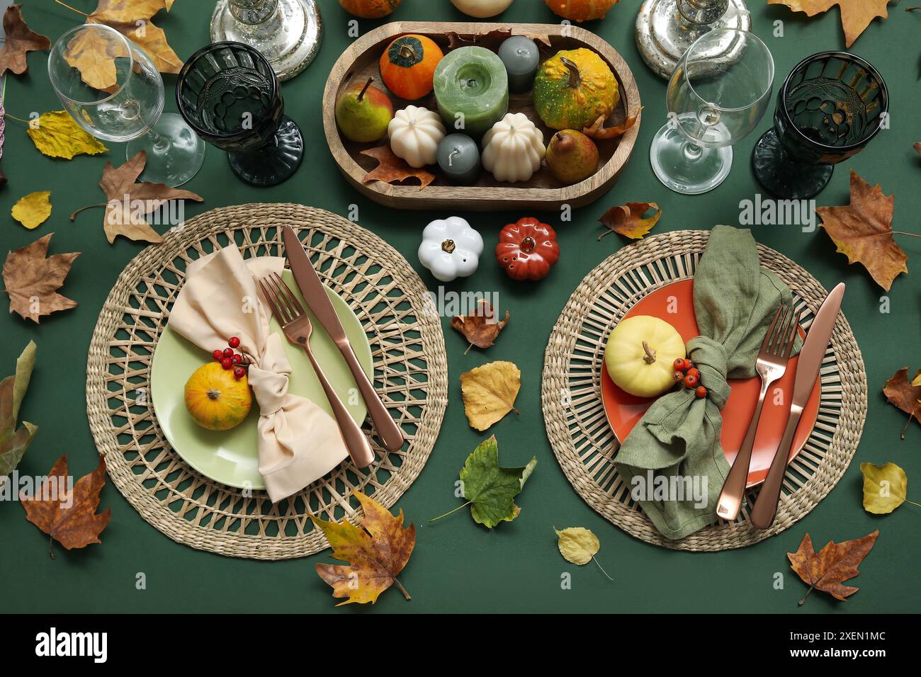 Autumn table serving with pumpkins and dry leaves on green table Stock ...