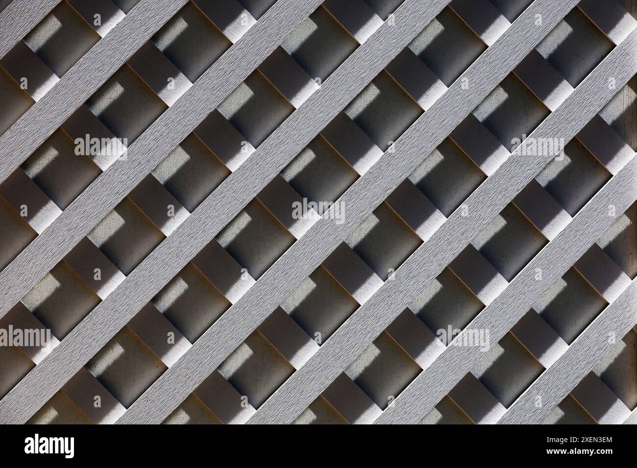 Photo of a white wooden lattice fence for background material Stock Photo