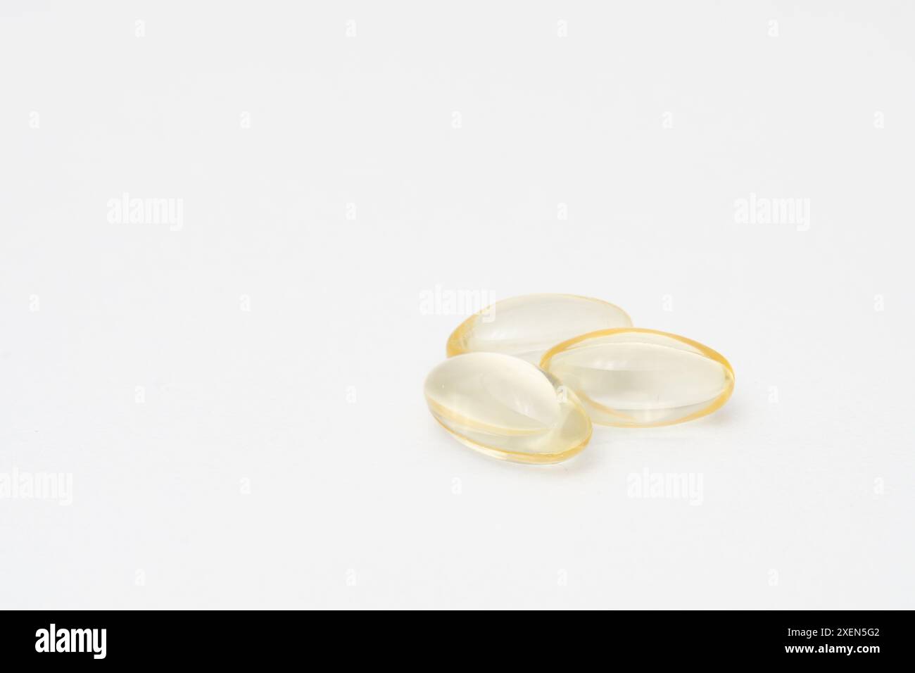 Close up of oil filled capsules (soft gel) suitable for presenting food supplements: fish oil, omega 3, omega 6, omega 9, vitamin A, vitamin D, D3, E Stock Photo