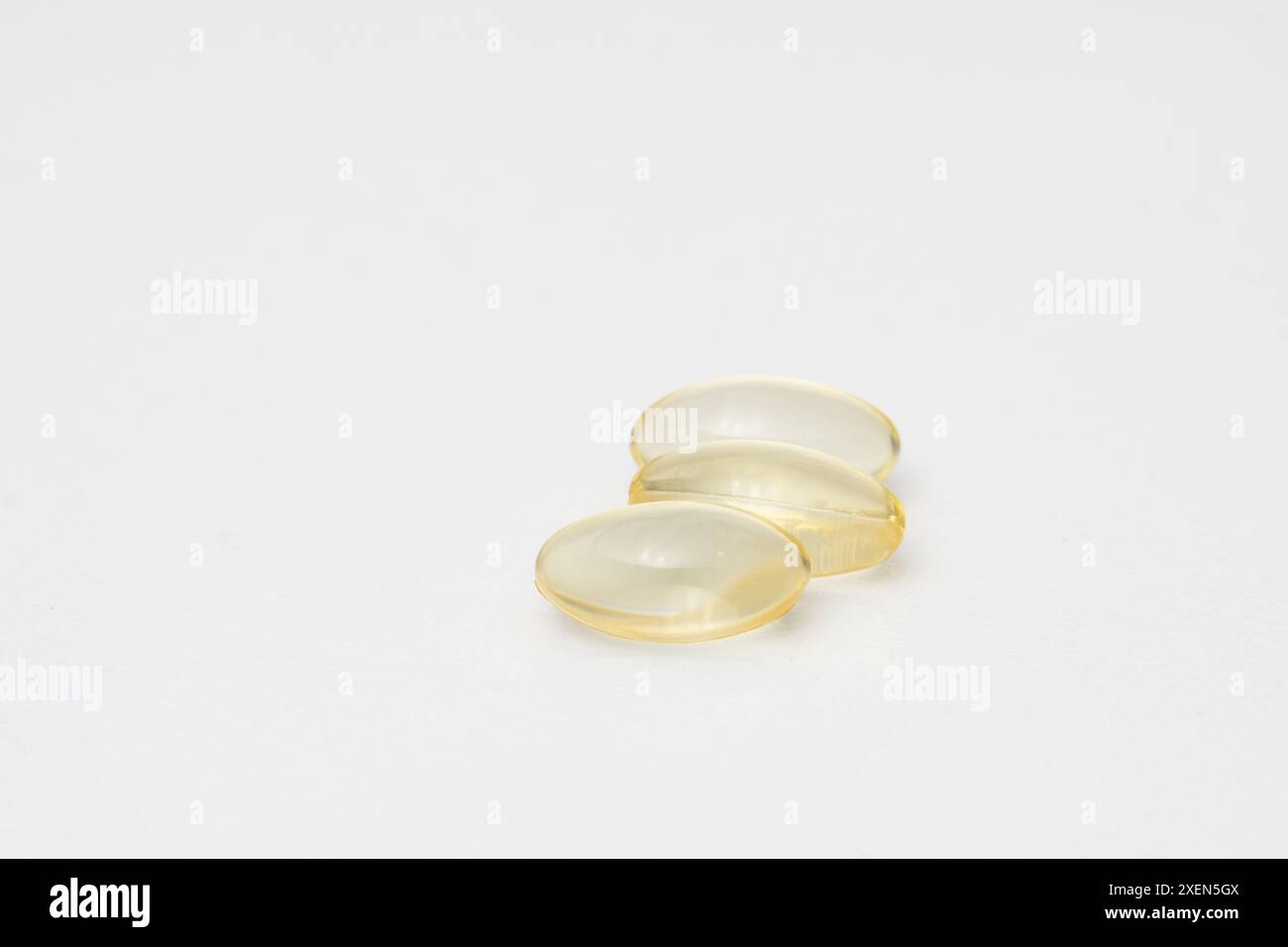 Close up of oil filled capsules (soft gel) suitable for presenting food supplements: fish oil, omega 3, omega 6, omega 9, vitamin A, vitamin D, D3, E Stock Photo