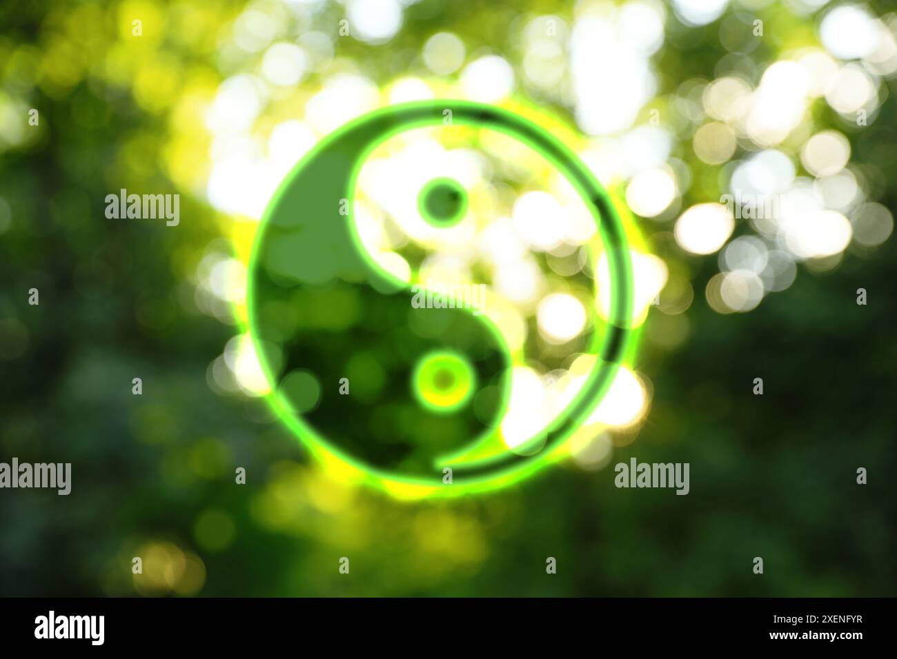 Yin and yang symbol against blurred green trees Stock Photo - Alamy