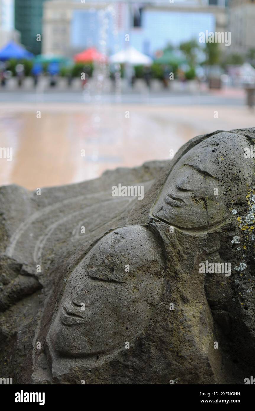 Faces carved into rocks at an open market by a fountain Stock Photo - Alamy