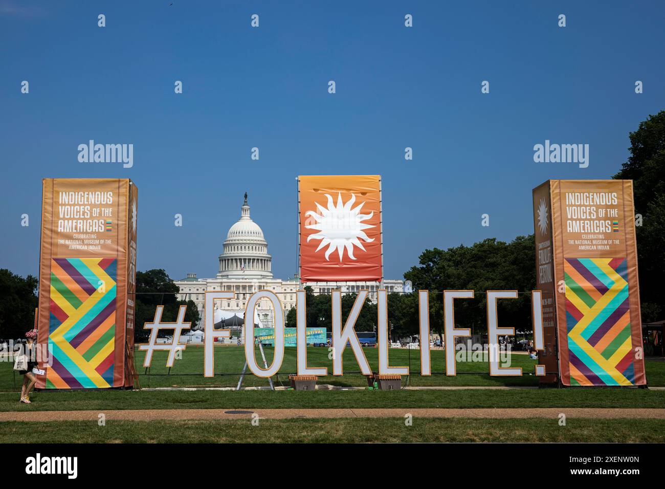 A large sign of the Smithsonian Folklife Festival is seen on the National Mall during the
