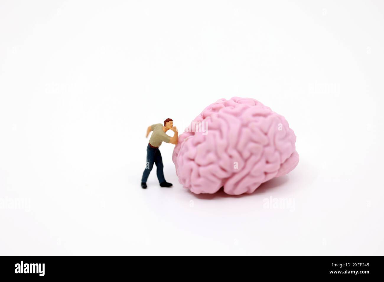 Compressed Brain Man a man arm wrestling with the brain Stock Photo - Alamy