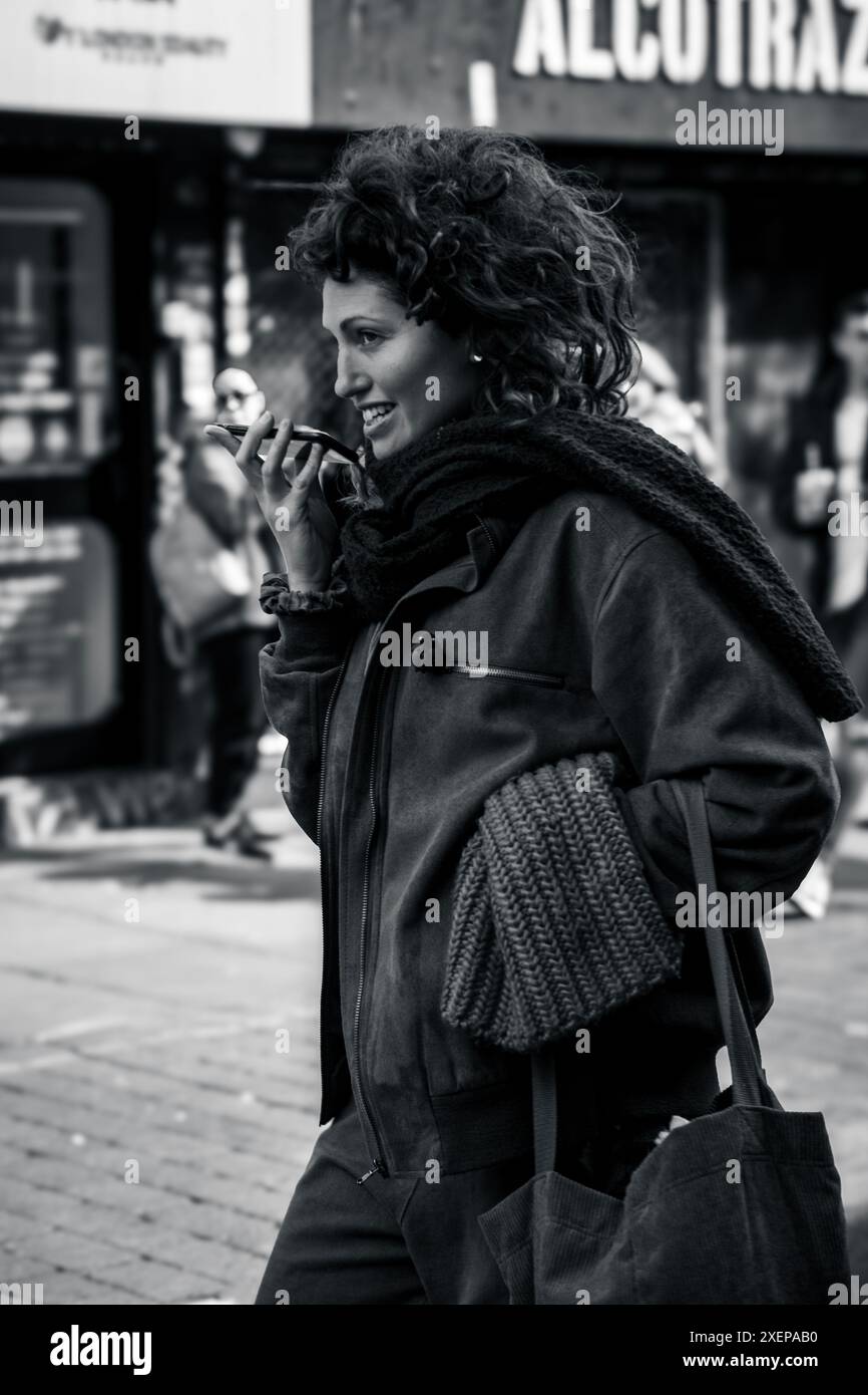 Woman in black coat walks hi-res stock photography and images - Alamy