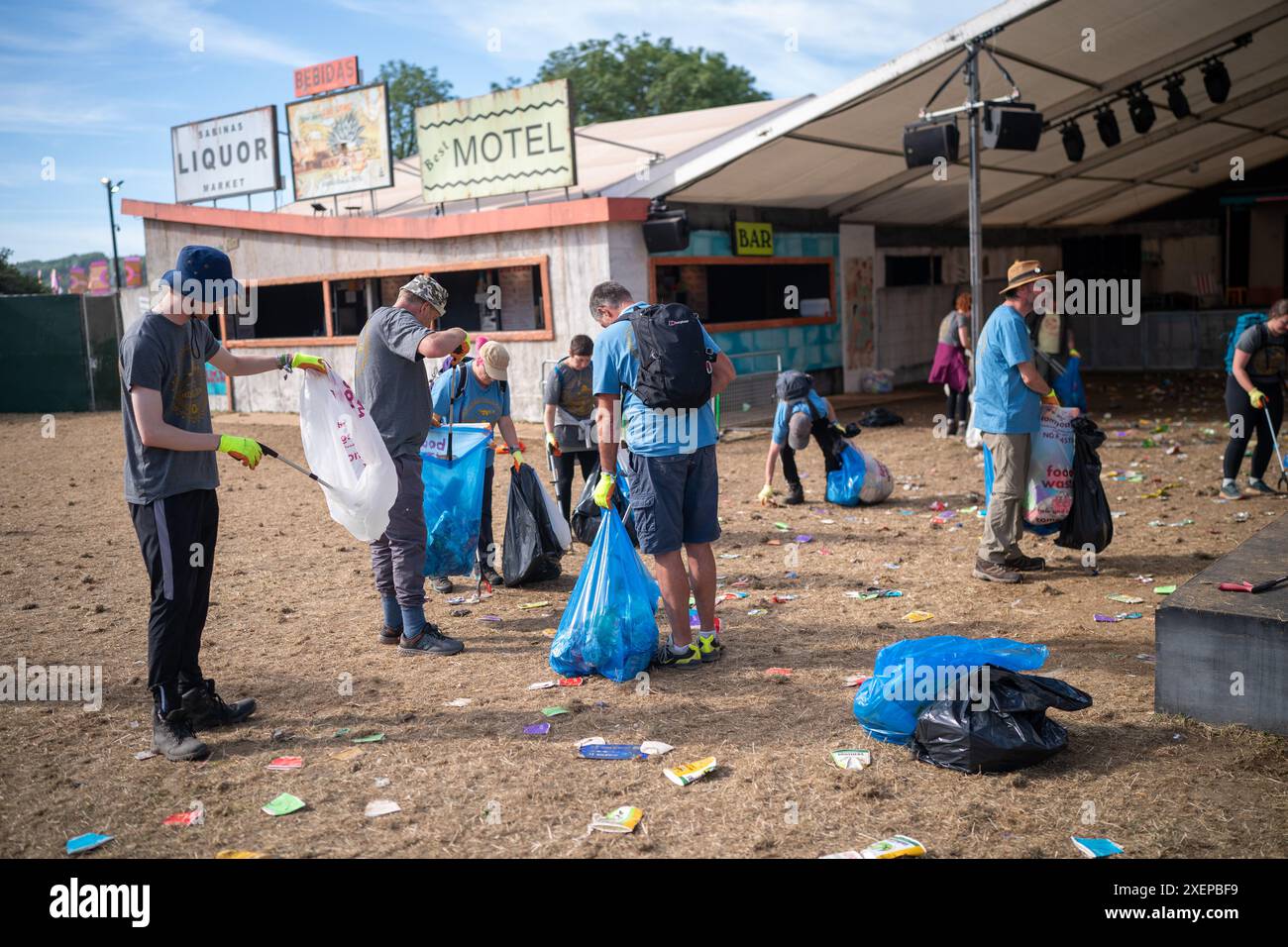 Cleaning crews pick litter outside San Remo at Glastonbury Festival, Worthy Farm in Somerset
