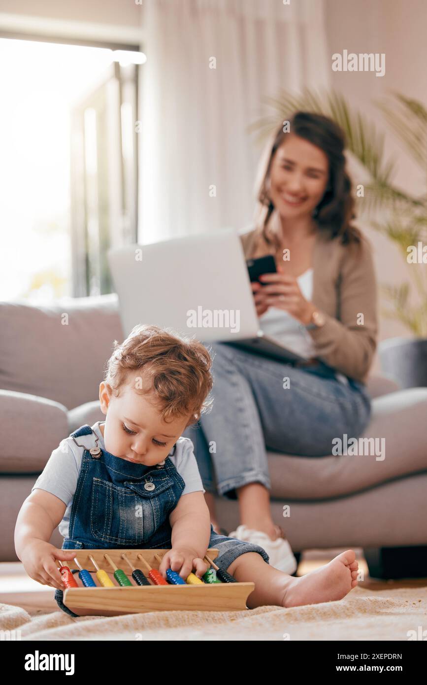 Mom, laptop and playing baby in home with remote work, reading email ...