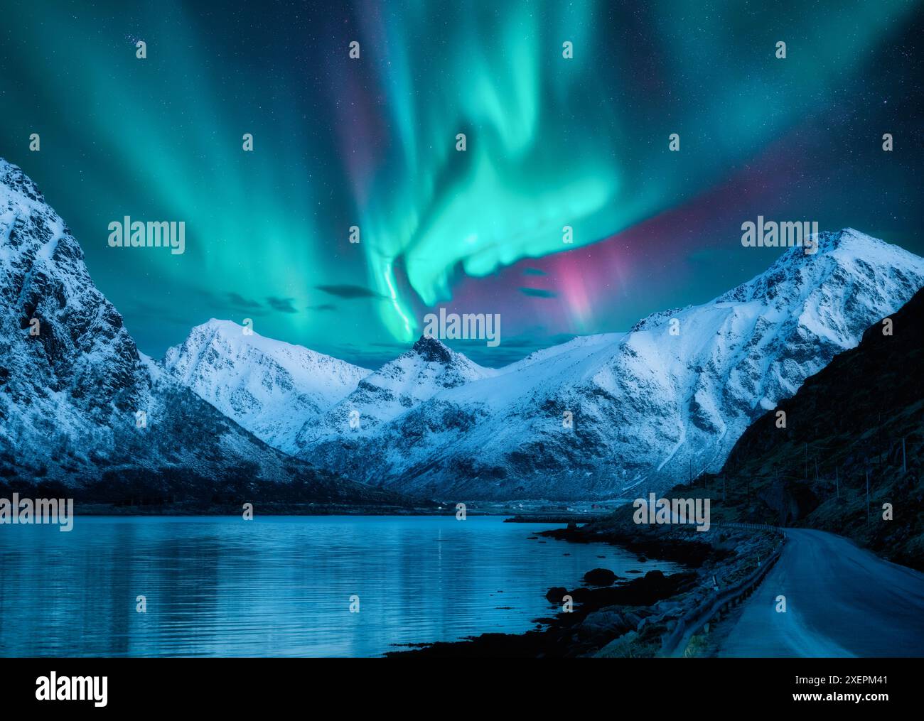 Northern lights over the snowy mountains, frozen sea, reflection in ...