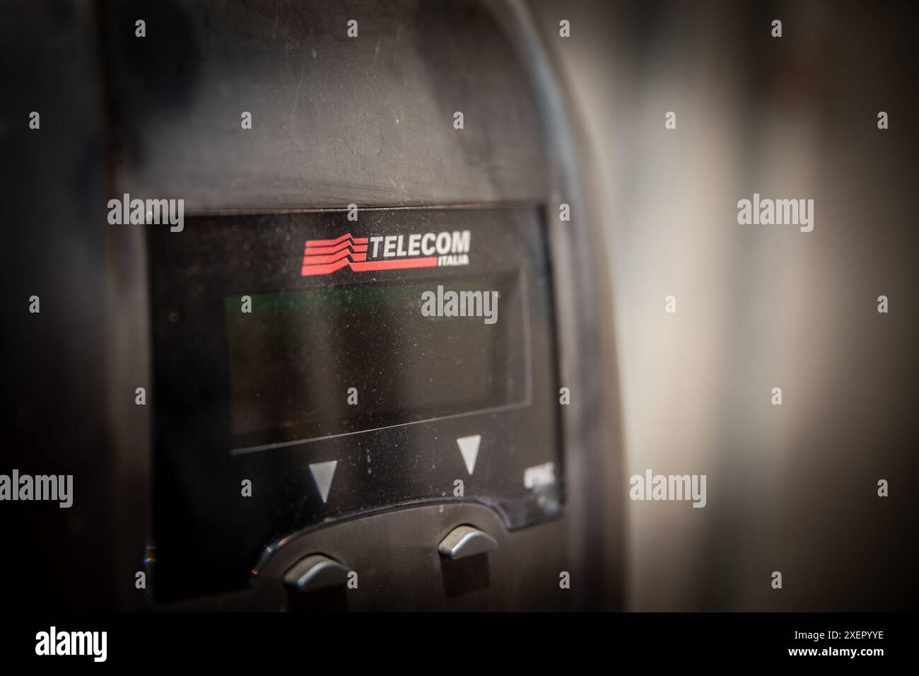 This image features the Telecom Italia logo on a vintage payphone. Telecom Italia, now known as TIM (Telecom Italia Mobile), is headquartered in Rome, Stock Photo