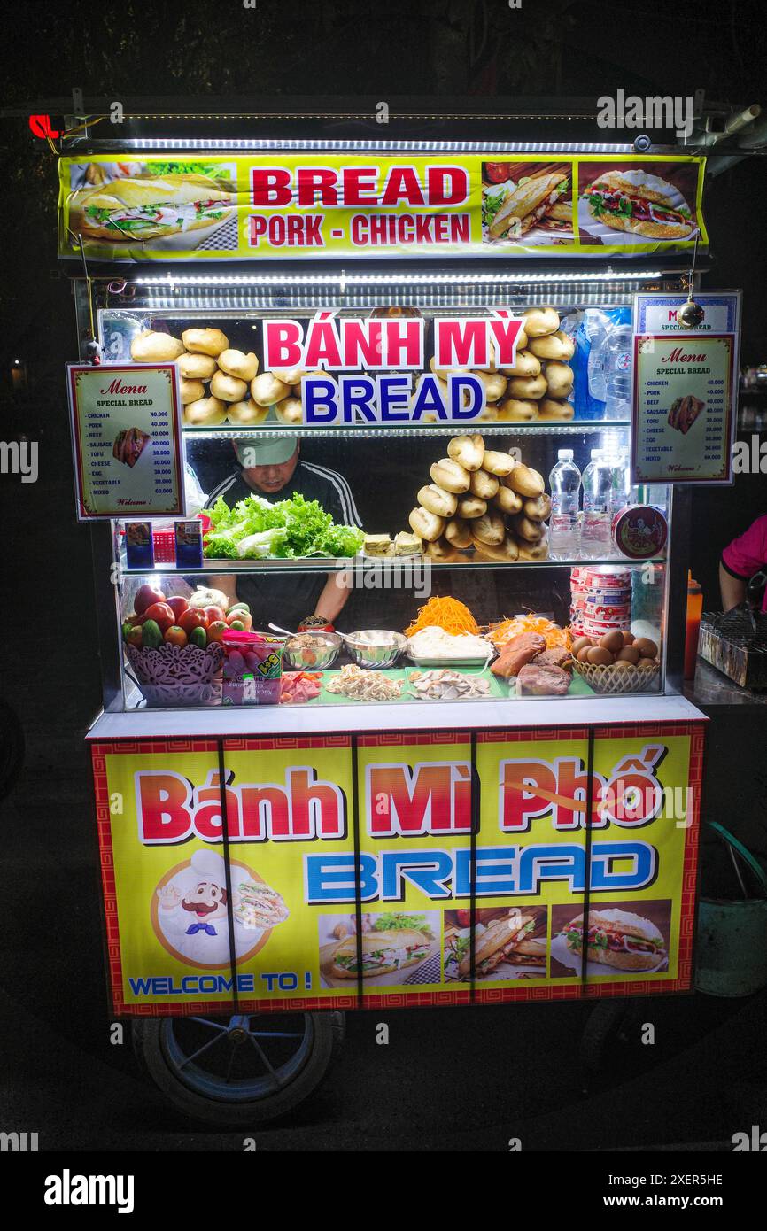 Hoi An, Vietnam - 5 Feb, 2024: Market vendor selling typical Banh Mi sandwich in Hoi An, Vietnam Stock Photo