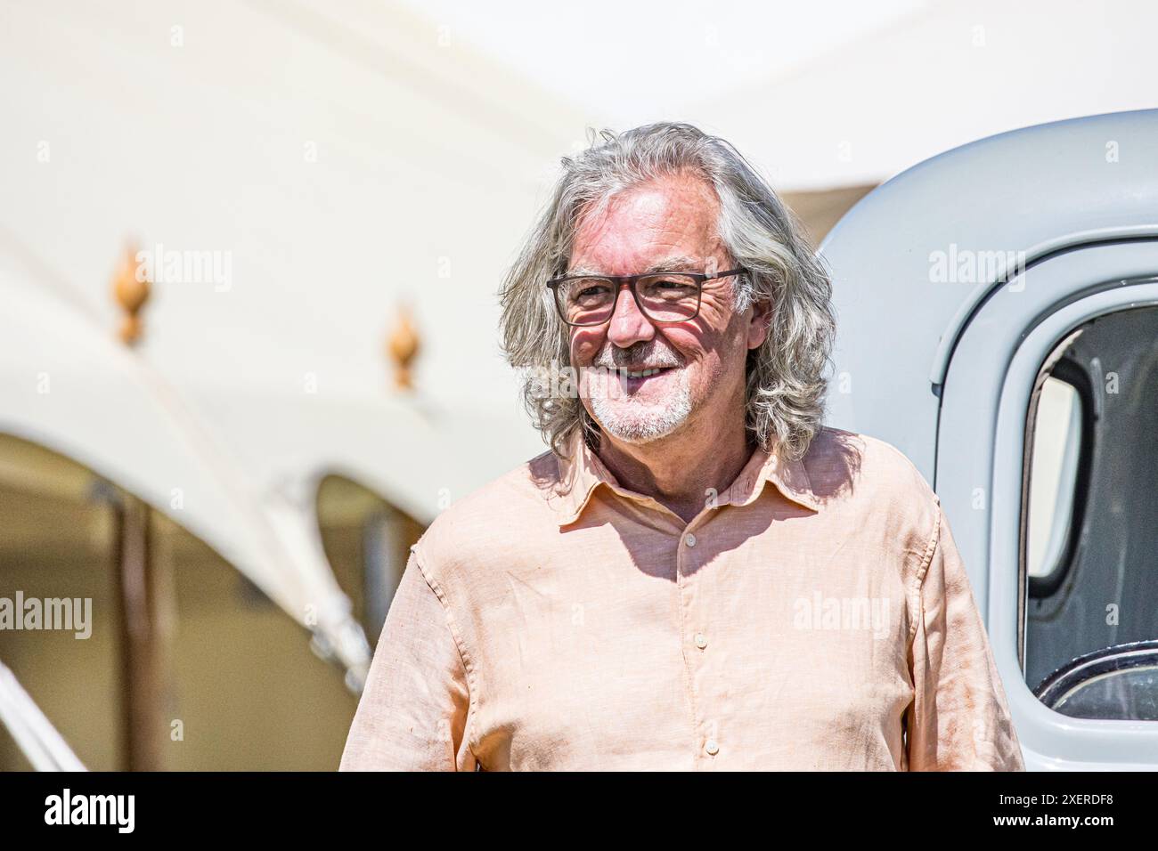 BROADCHALKE, SALISBURY, WILTSHIRE, UK, 29th June, 2024, The Grand Tour and former Top Gear presenter, television personality James May standing in front of a vintage Chevrolet in the sunshine while visiting the Chalke History Festival to give his talk entitled 'The Car: Did we get it wrong?' with James Holland. Credit John Rose/Alamy Live News Stock Photo