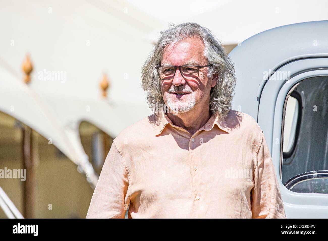 BROADCHALKE, SALISBURY, WILTSHIRE, UK, 29th June, 2024, The Grand Tour and former Top Gear presenter, television personality James May standing in front of a vintage Chevrolet in the sunshine while visiting the Chalke History Festival to give his talk entitled 'The Car: Did we get it wrong?' with James Holland. Credit John Rose/Alamy Live News Stock Photo