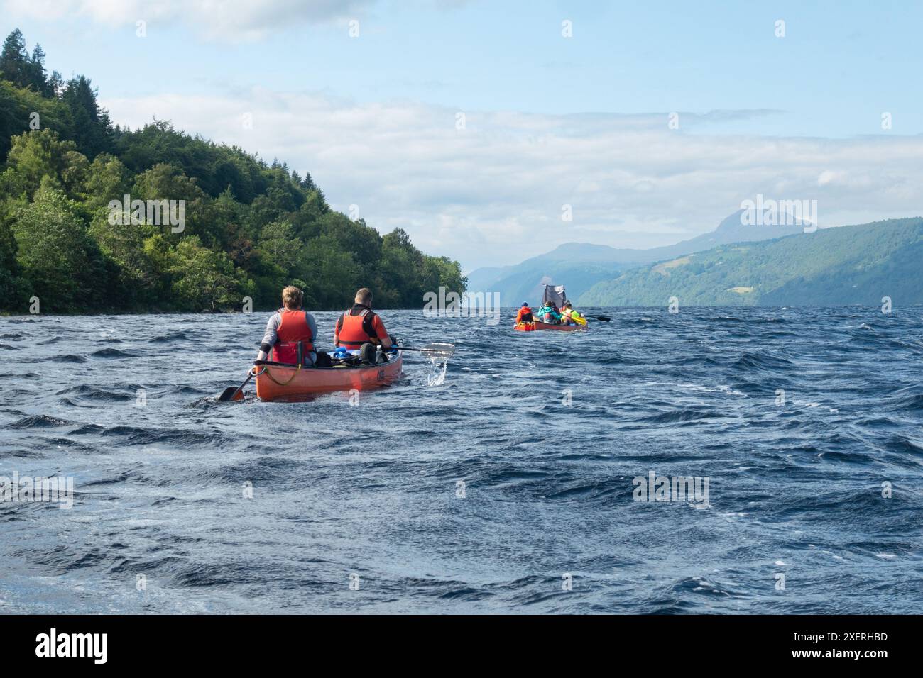 Great Glen Canoe Trail people in canoes paddling and using sails to