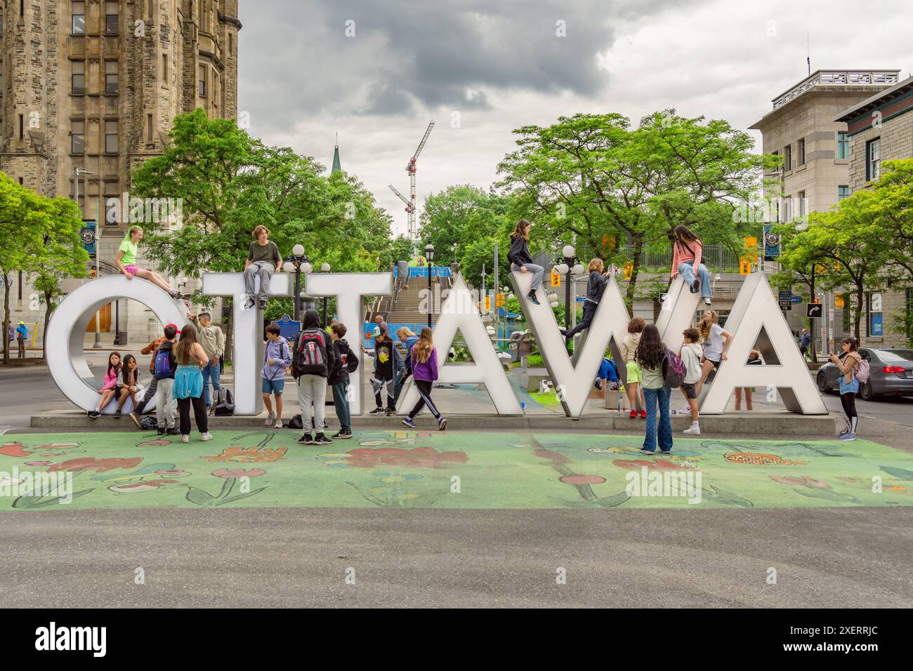 Ottawa, ON, Canada-June 12, 2024: The huge Ottawa sign in the Byward Market with children from a school group. Stock Photo