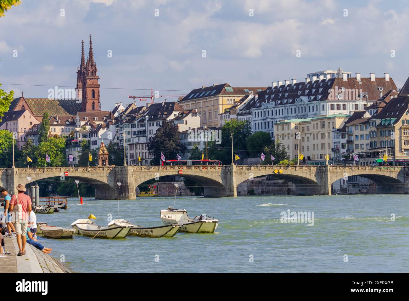Basel city- A bridge spans Rhein river with a city in the background ...