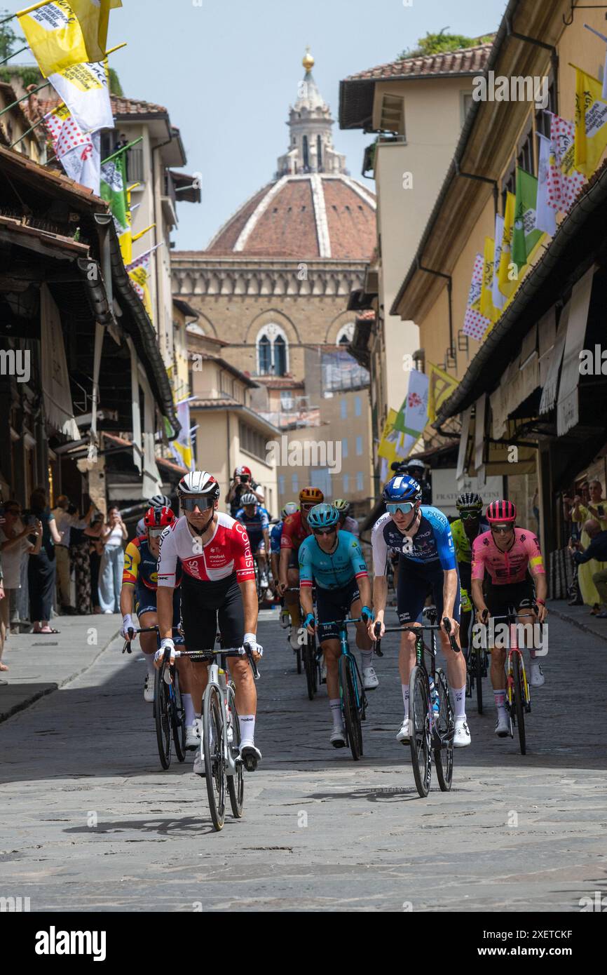 The pack of riders cycles on Ponte Vecchio during Stage 1 - Start, Tour ...