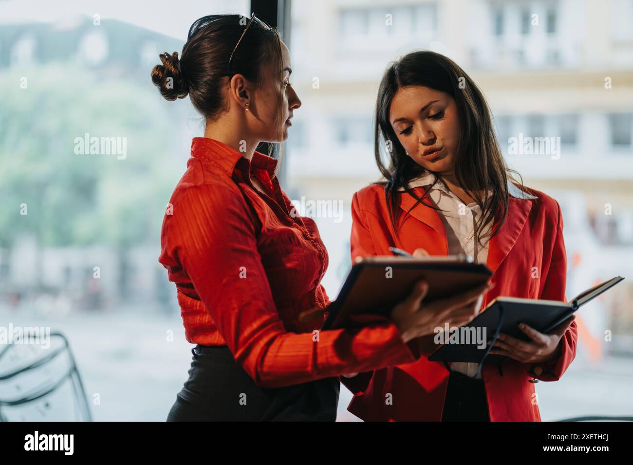 Young business entrepreneurs discussing during a meeting with notebooks Stock Photo