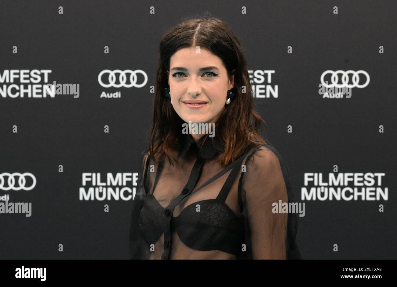 Munich, Germany. 29th June, 2024. Model Marie Nasemann walks the turquoise carpet to the opening gala with the world premiere of the comedy 'Zwei zu eins' at the Isarphilharmonie in HP8 as part of the Munich Film Festival. Credit: Felix Hörhager/dpa/Alamy Live News Stock Photo