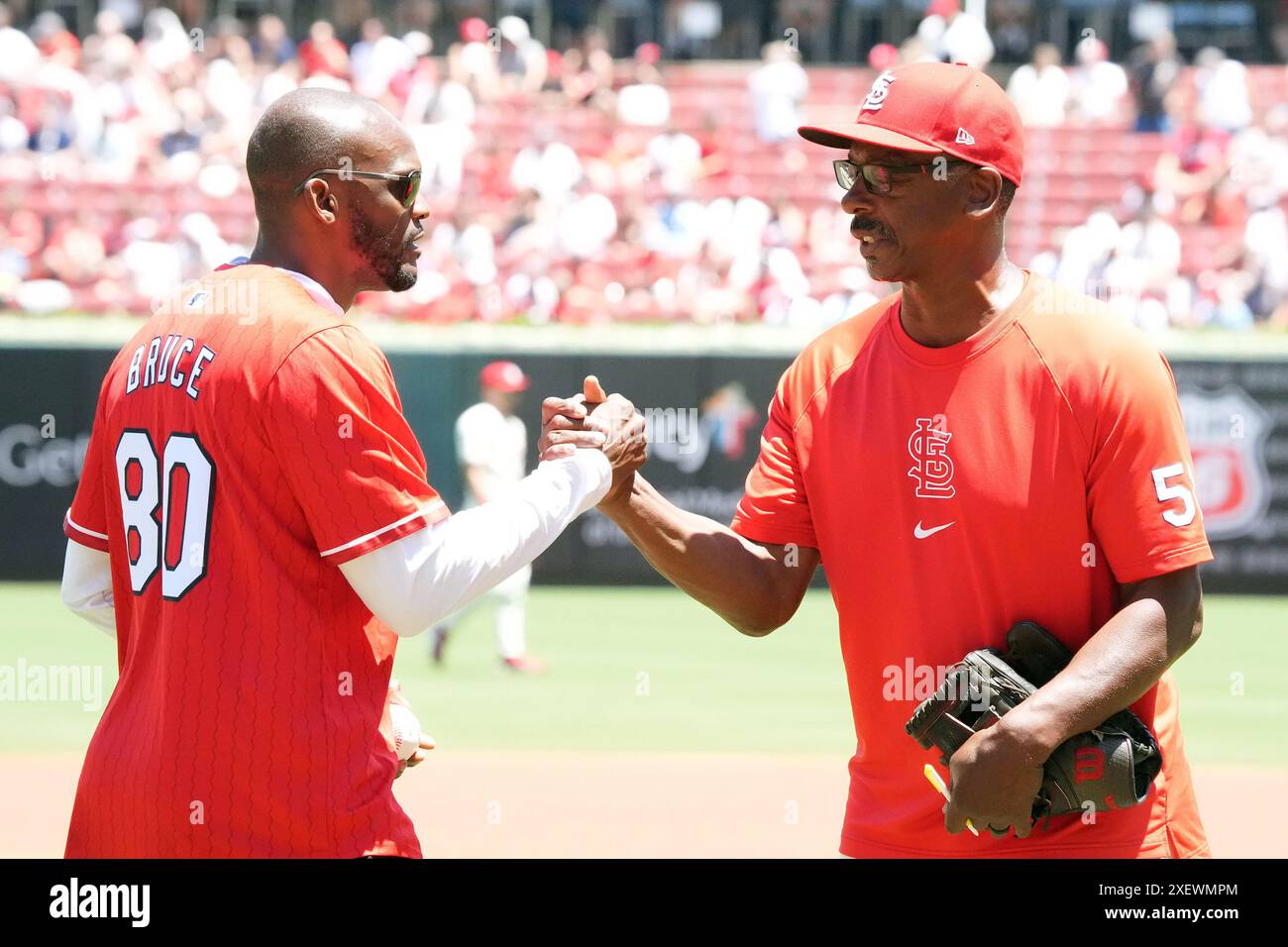 St. Louis, United States. 29th June, 2024. Football Hall Of Fame Member Isaac Bruce (L) greets St. Louis Cardinals coach Willie McGee in pre game ceremonies before the Cincinnati Reds - St. Louis Cardinals baseball game at Busch Stadium in St. Louis on Saturday, June 29, 2024. Photo by Bill Greenblatt/UPI Credit: UPI/Alamy Live News Stock Photo