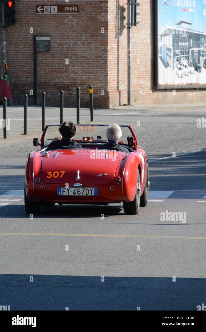 FERRARA , ITALY - jun 15 -2024 : A classic car races through the