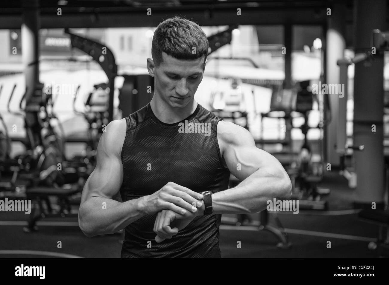 fit athlete monitoring physical activity by smartwatch in gym. fit ...