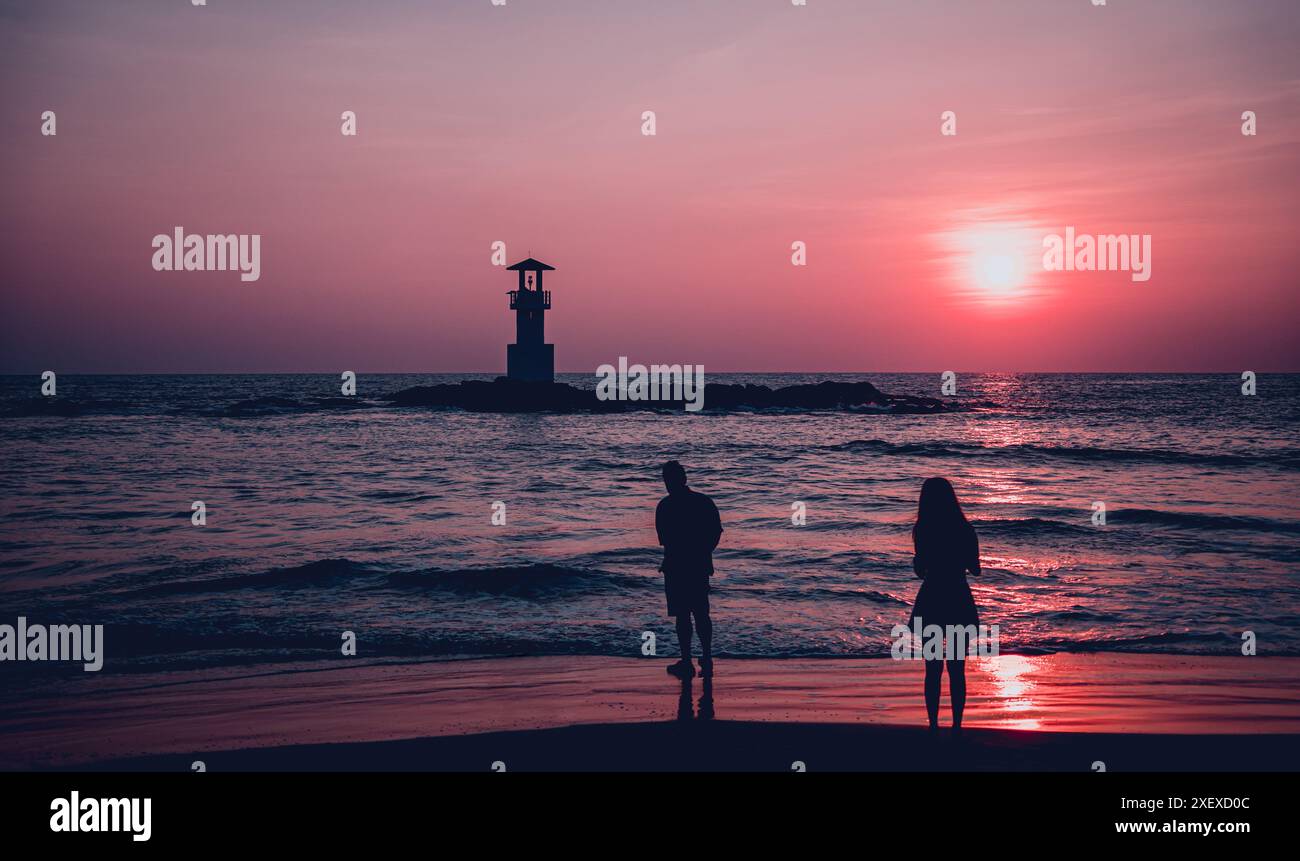 A lighthouse in the ocean during a beautiful sunset Stock Photo - Alamy