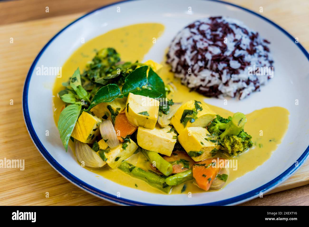 Traditional vegetable green curry with herbs and steamed rice Stock ...