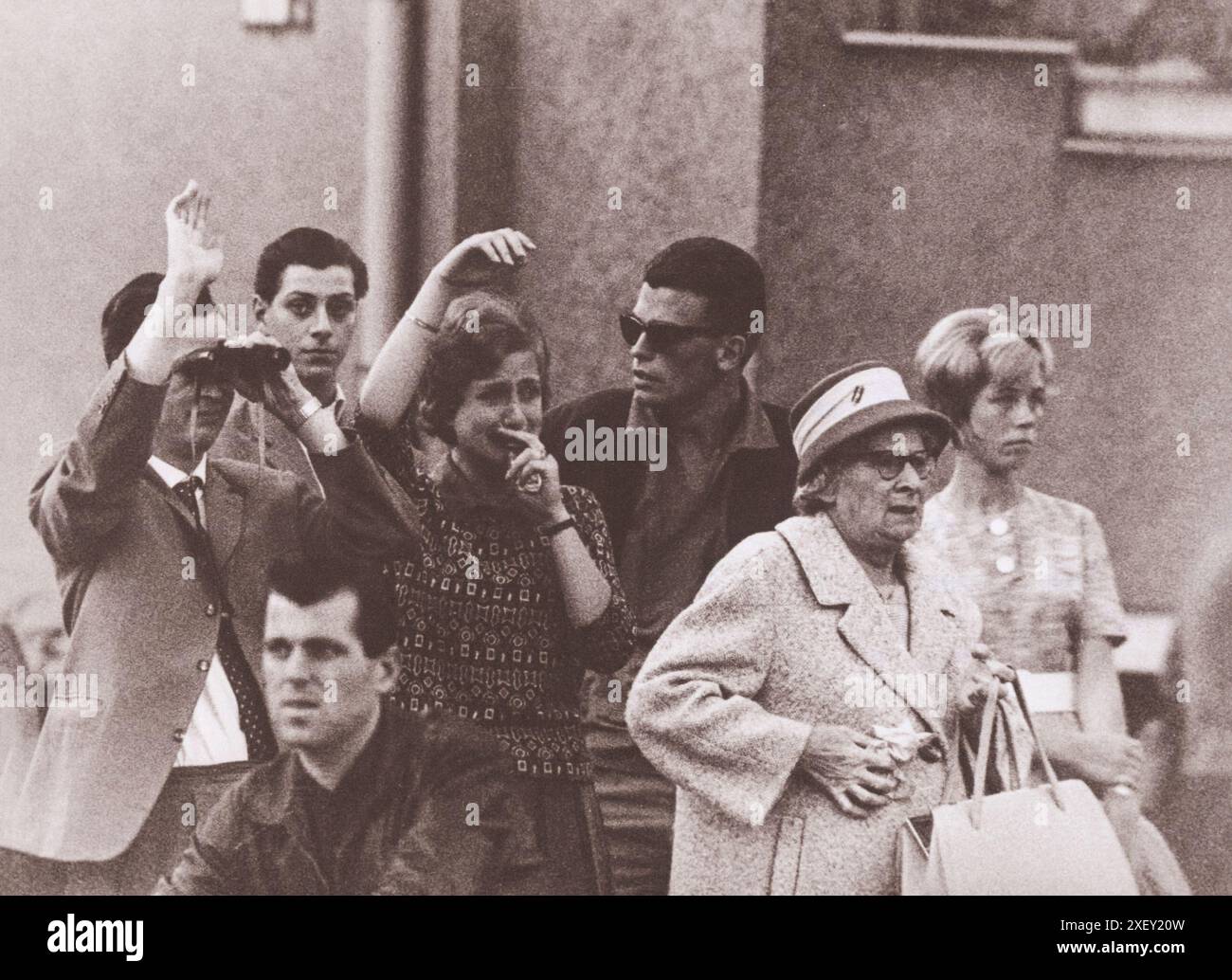 Vintage photo of Berlin Crisis of 1961: Building the Wall Tears In West Berlin. A Young Couple In West Berlin Looks Across the Dividing Line at Family and Friends Left Behind in the Eastern Sector. Berlin, October 1961. Stock Photo