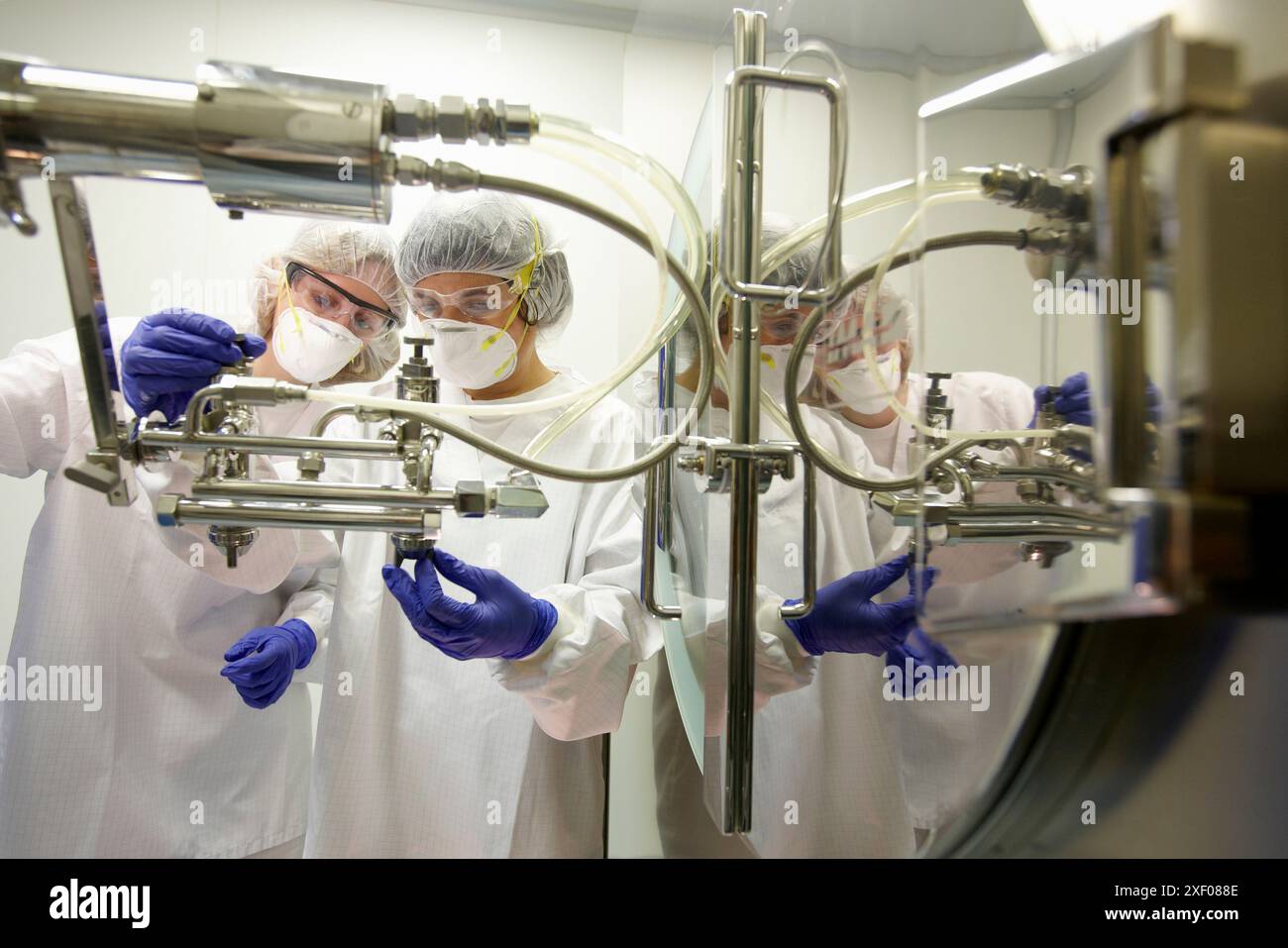 Technicians performing maintenance functions on a solid coating machine ...