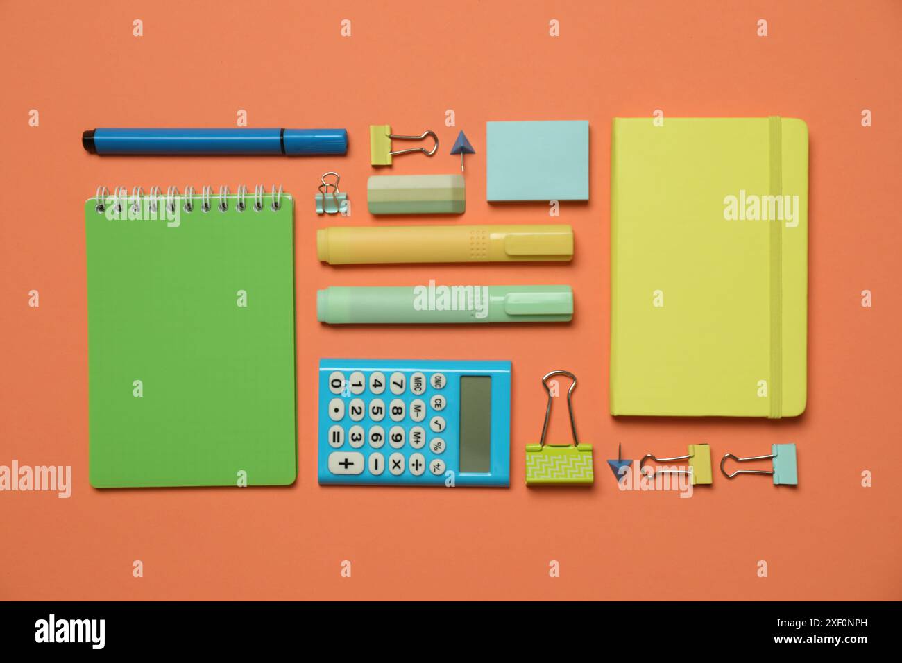 Flat lay composition with notebooks and different stationery on orange background Stock Photo