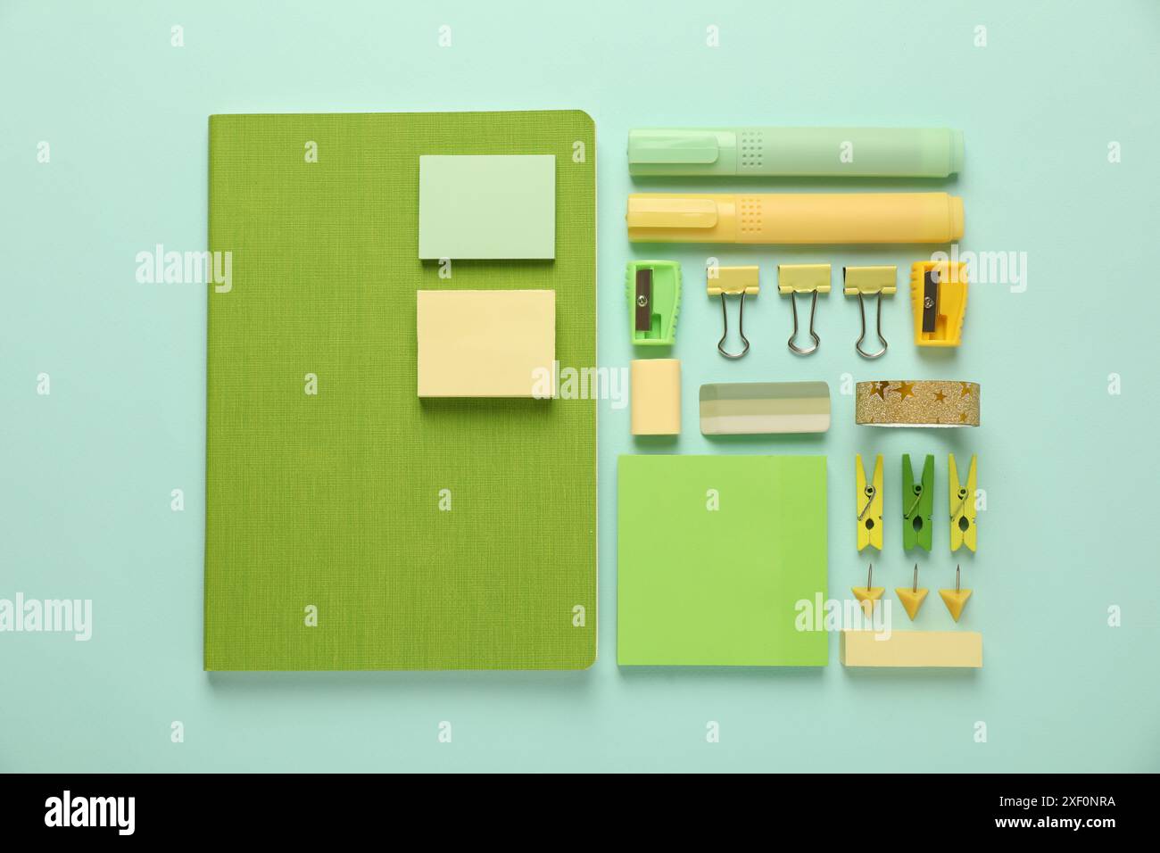 Flat lay composition with notebooks and different stationery on turquoise background Stock Photo