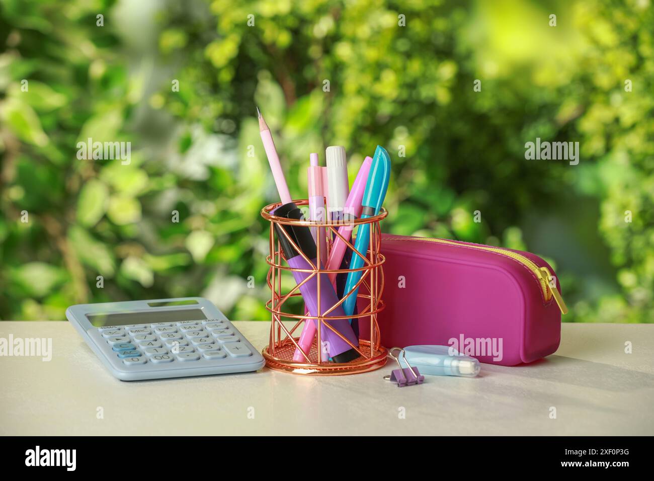 Holder, pencil case, calculator and other different stationery on white table Stock Photo