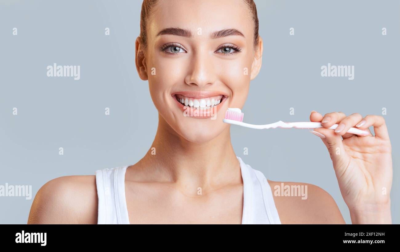 Woman Brushing Teeth With Toothbrush and Toothpaste Stock Photo