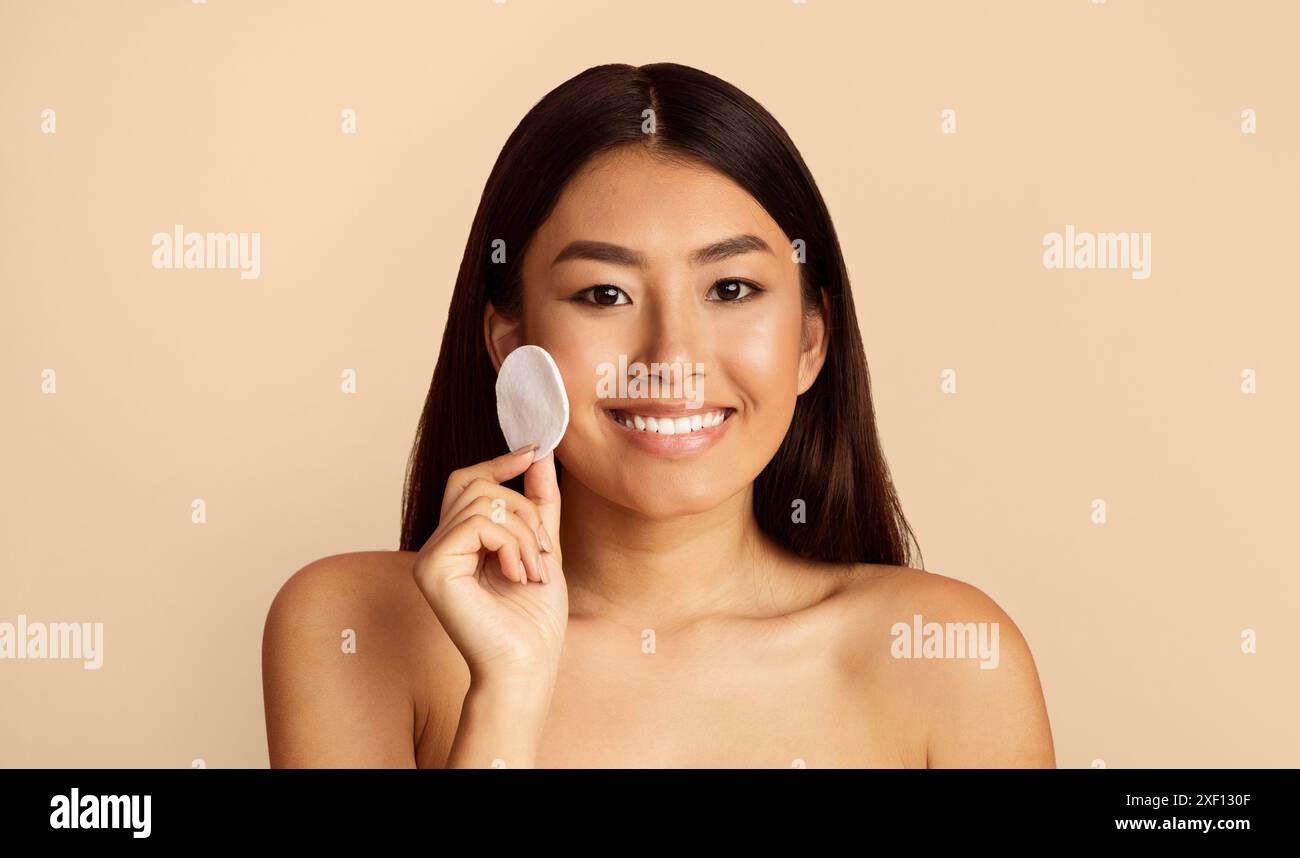 Asian model applying lips hi-res stock photography and images - Alamy