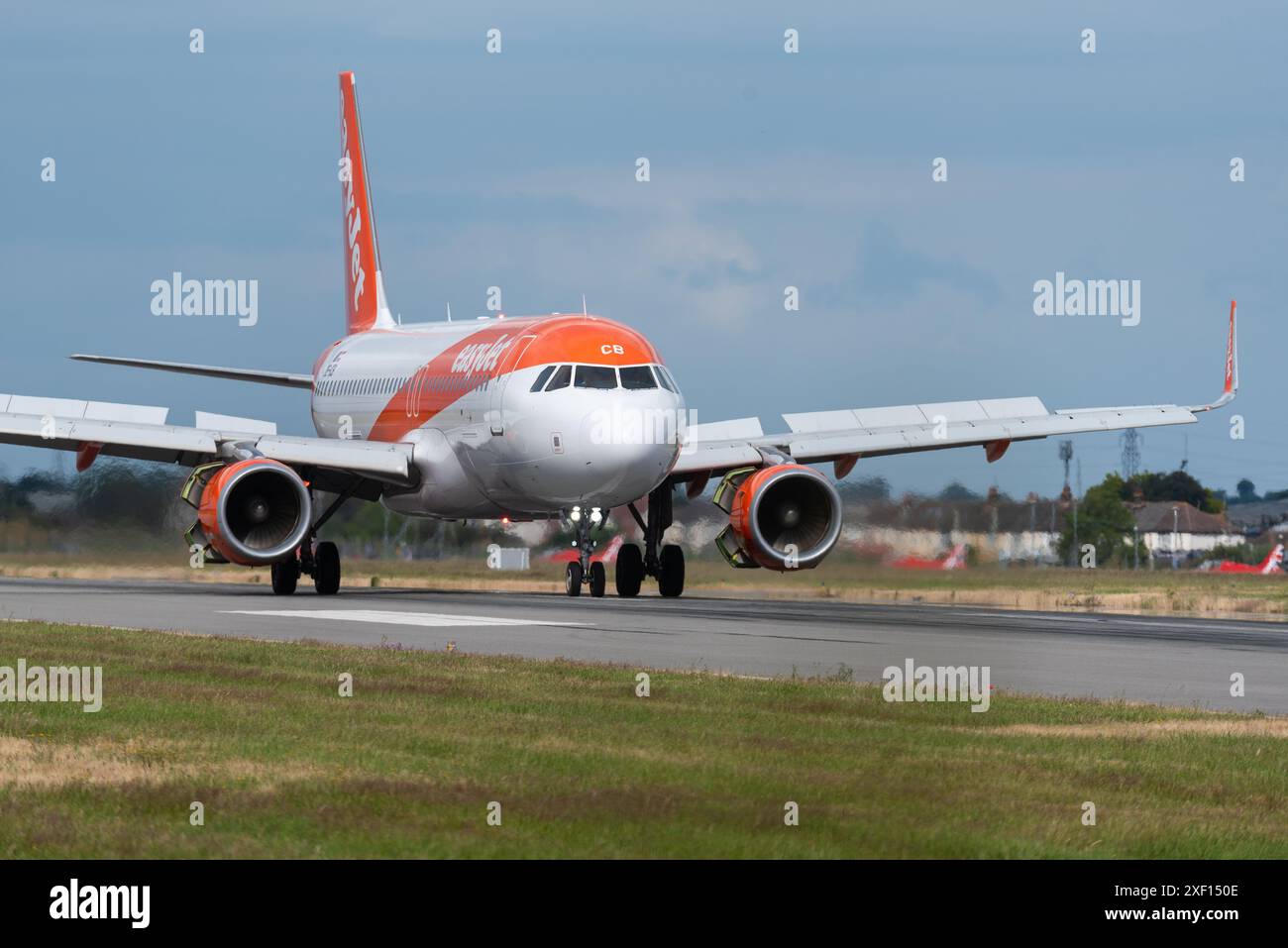 Royal Air Force Red Arrows display team using London Southend Airport, Essex, UK, as an operational base for a south east airshow, behind easyJet jet Stock Photo