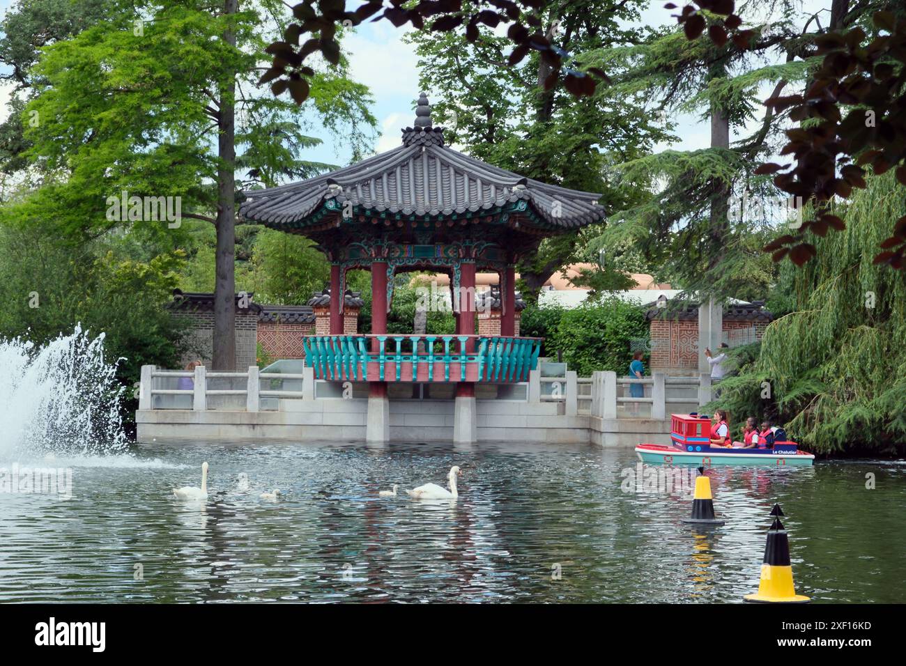 The Canots du Lac with a Korean Temple in the background at the jardin d'acclimatation a children's amusement park in the Bois de Boulogne in Paris Stock Photo