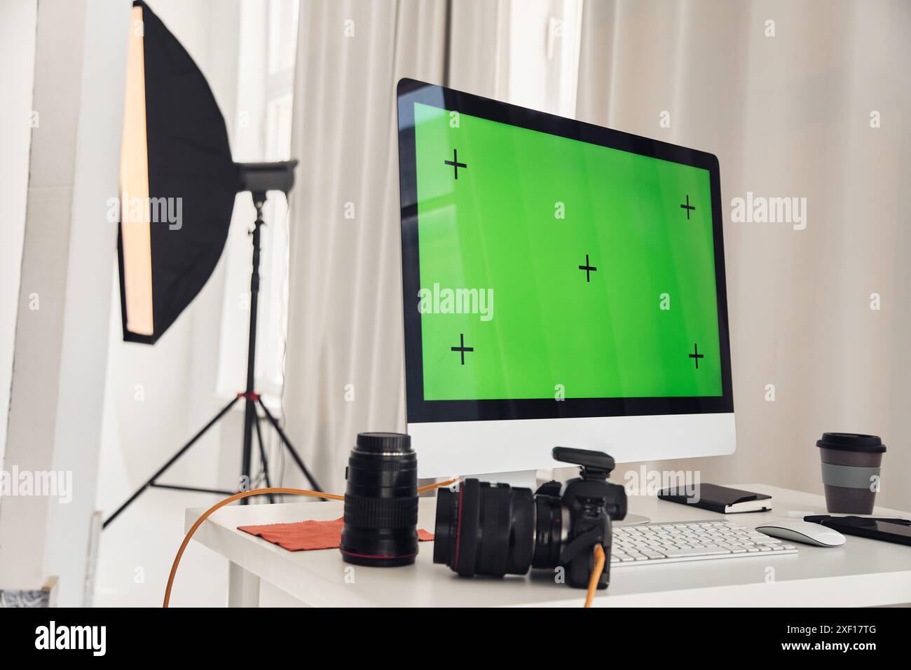 Background image of PC computer with green screen in photo studio with cameras and equipment on white table, copy space  Stock Photo