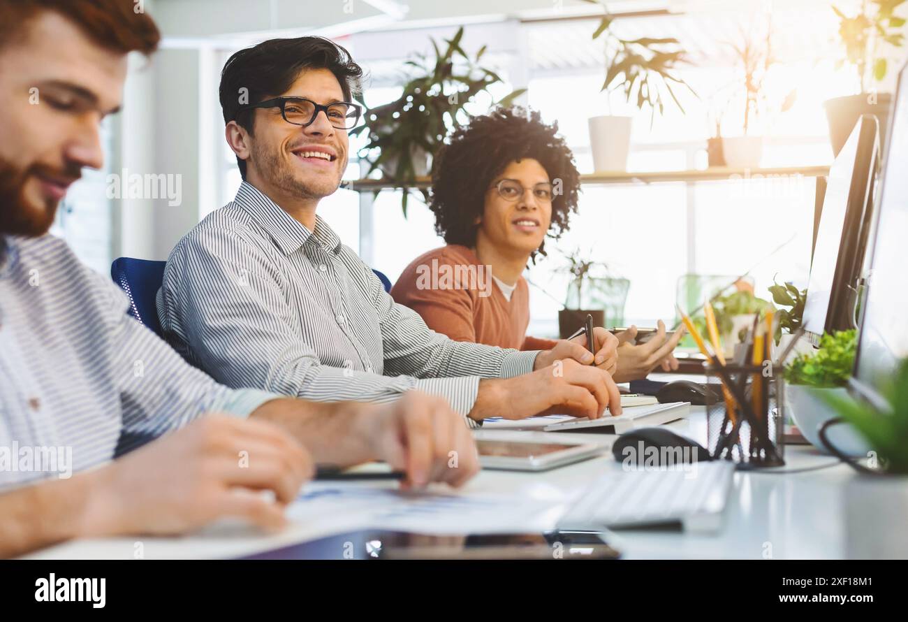 Young male team working at IT developing company Stock Photo
