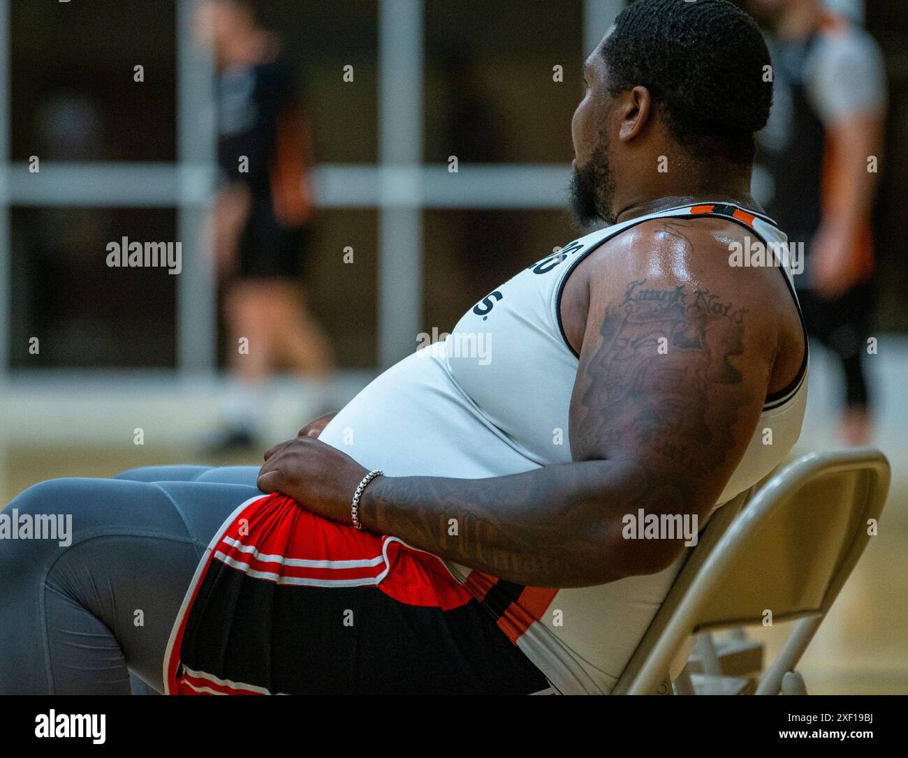 An overweight male basketball player at a game Stock Photo
